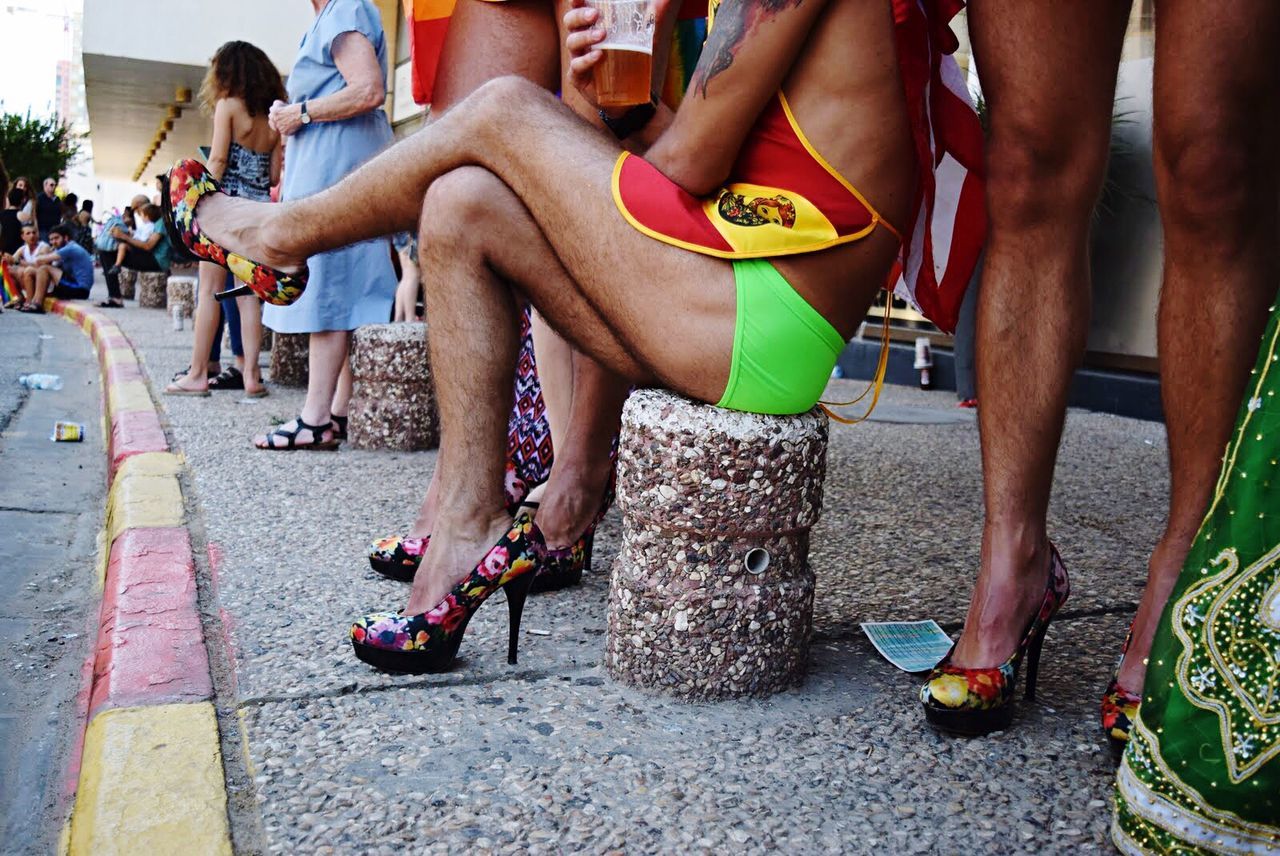 Low section of people on sidewalk during gay pride parade