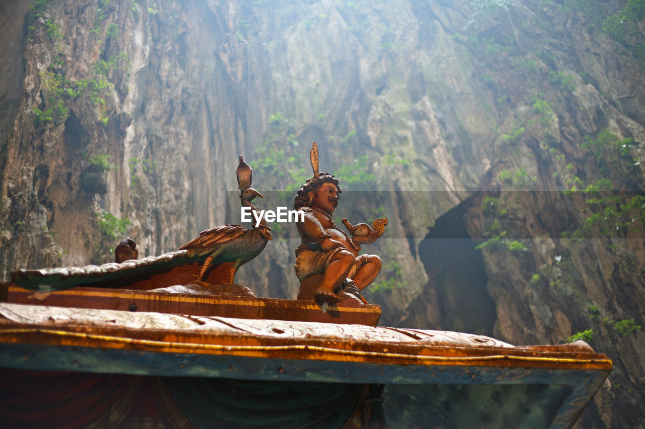 Close-up of statue against mountain