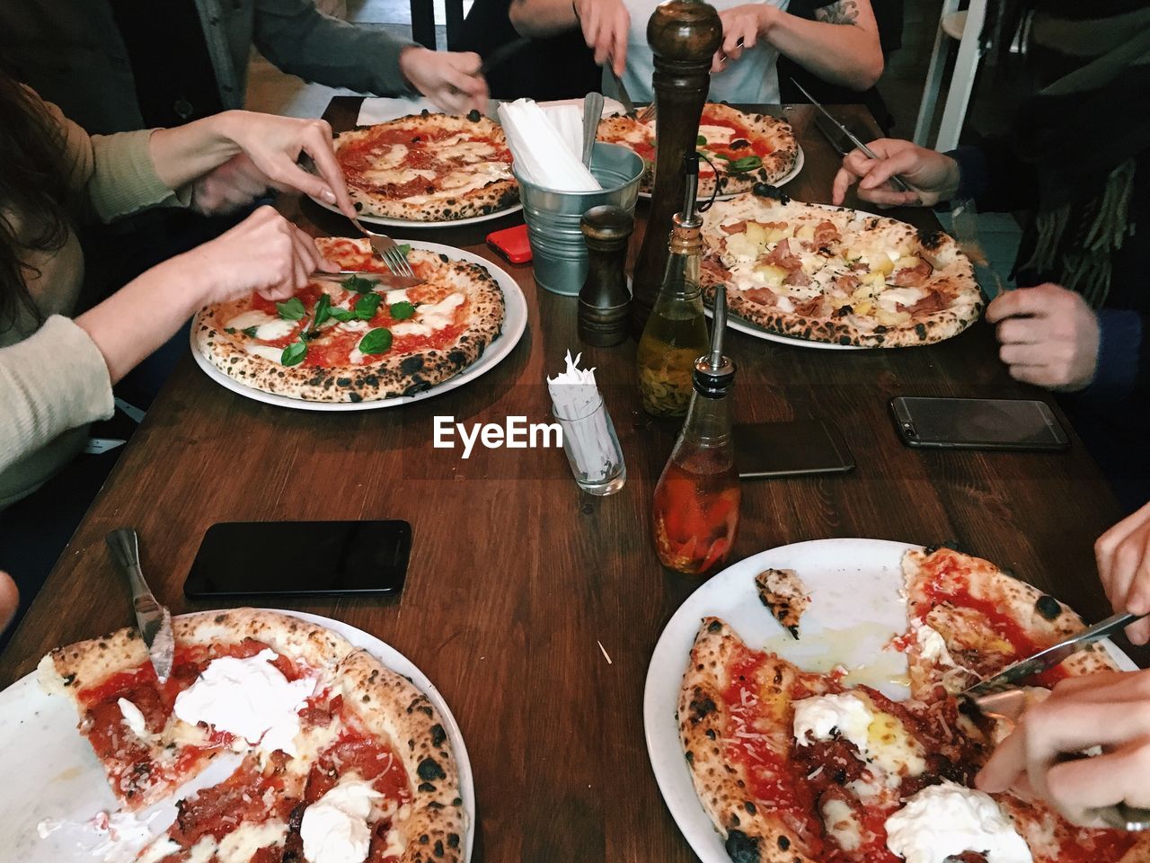 High angle view of friends eating pizza