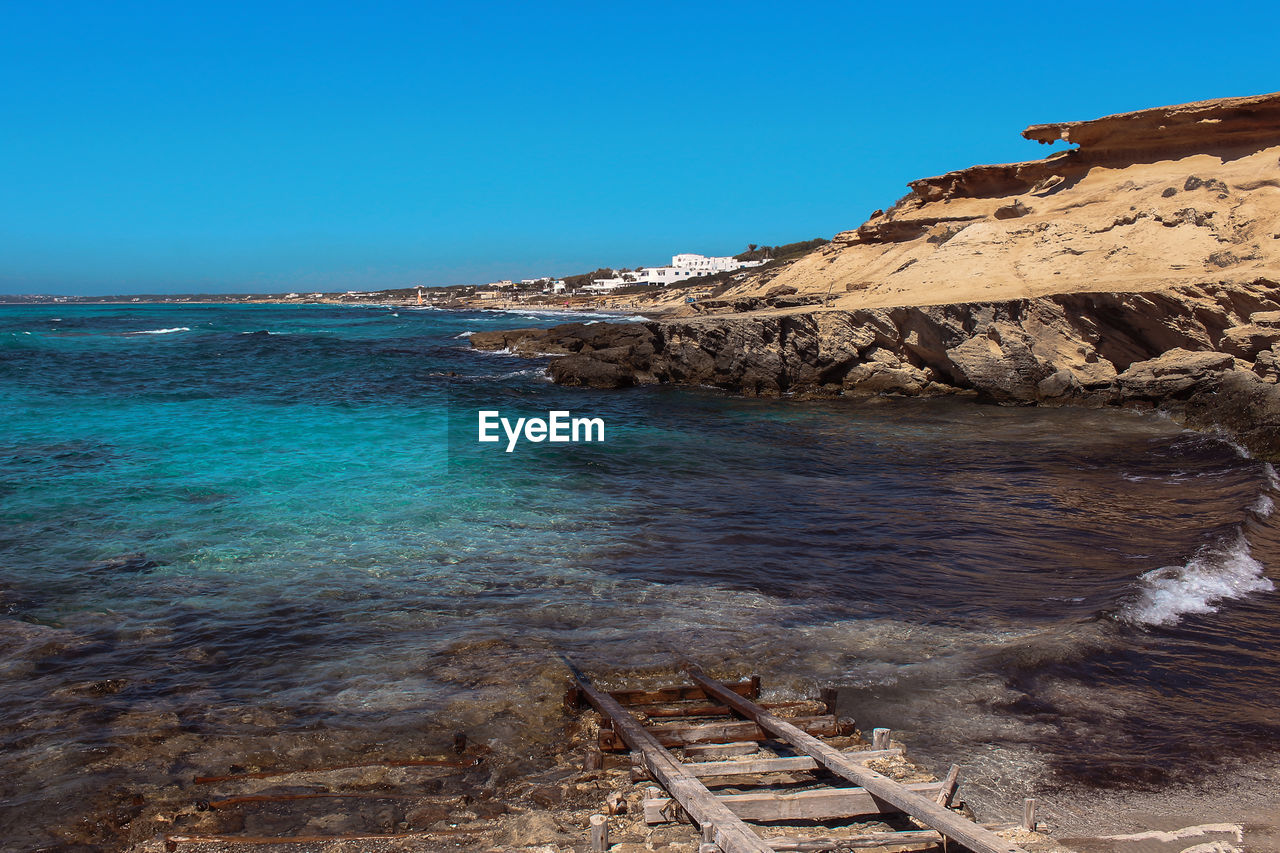 Scenic view of sea against clear blue sky