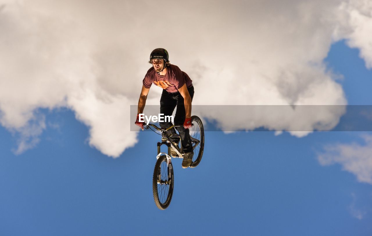 FULL LENGTH OF WOMAN JUMPING IN MID-AIR