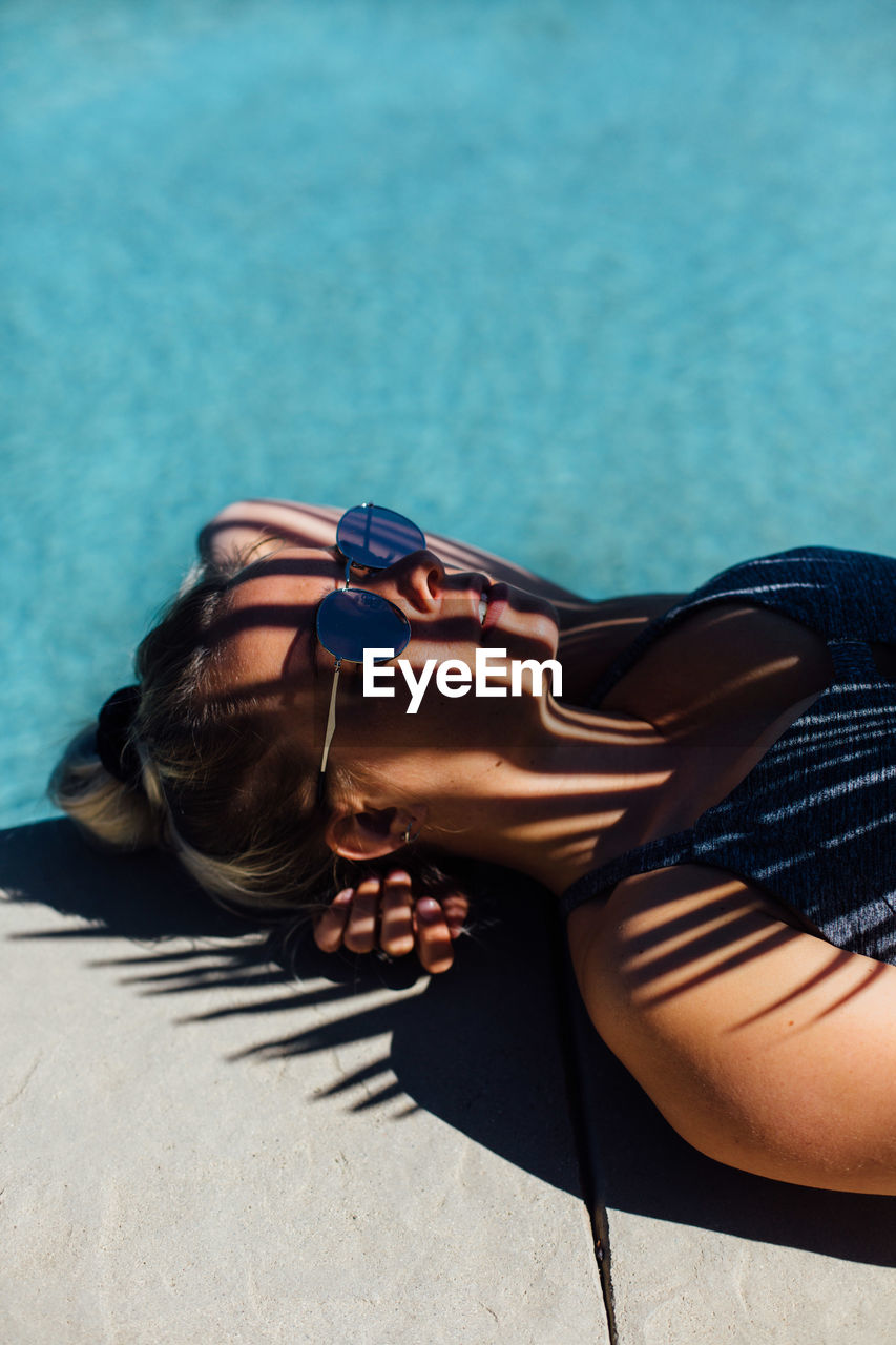 Woman relaxing poolside