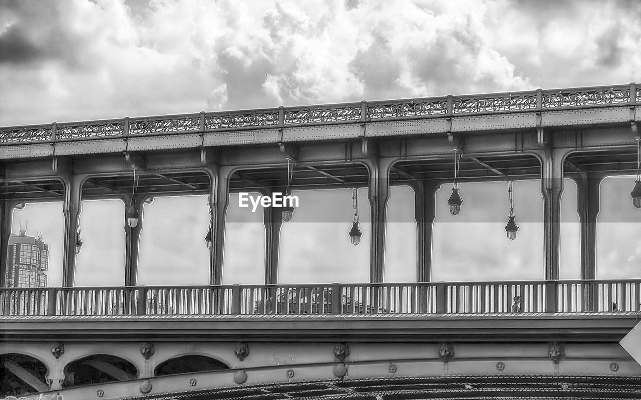 architecture, built structure, cloud, transport, black and white, bridge, sky, monochrome, monochrome photography, transportation, overpass, public transport, rail transportation, building exterior, nature, city, architectural column, no people, travel, day, train, low angle view, public transportation, travel destinations, viaduct, railway bridge, outdoors, arch, mode of transportation, railing, landmark, tourism, the past