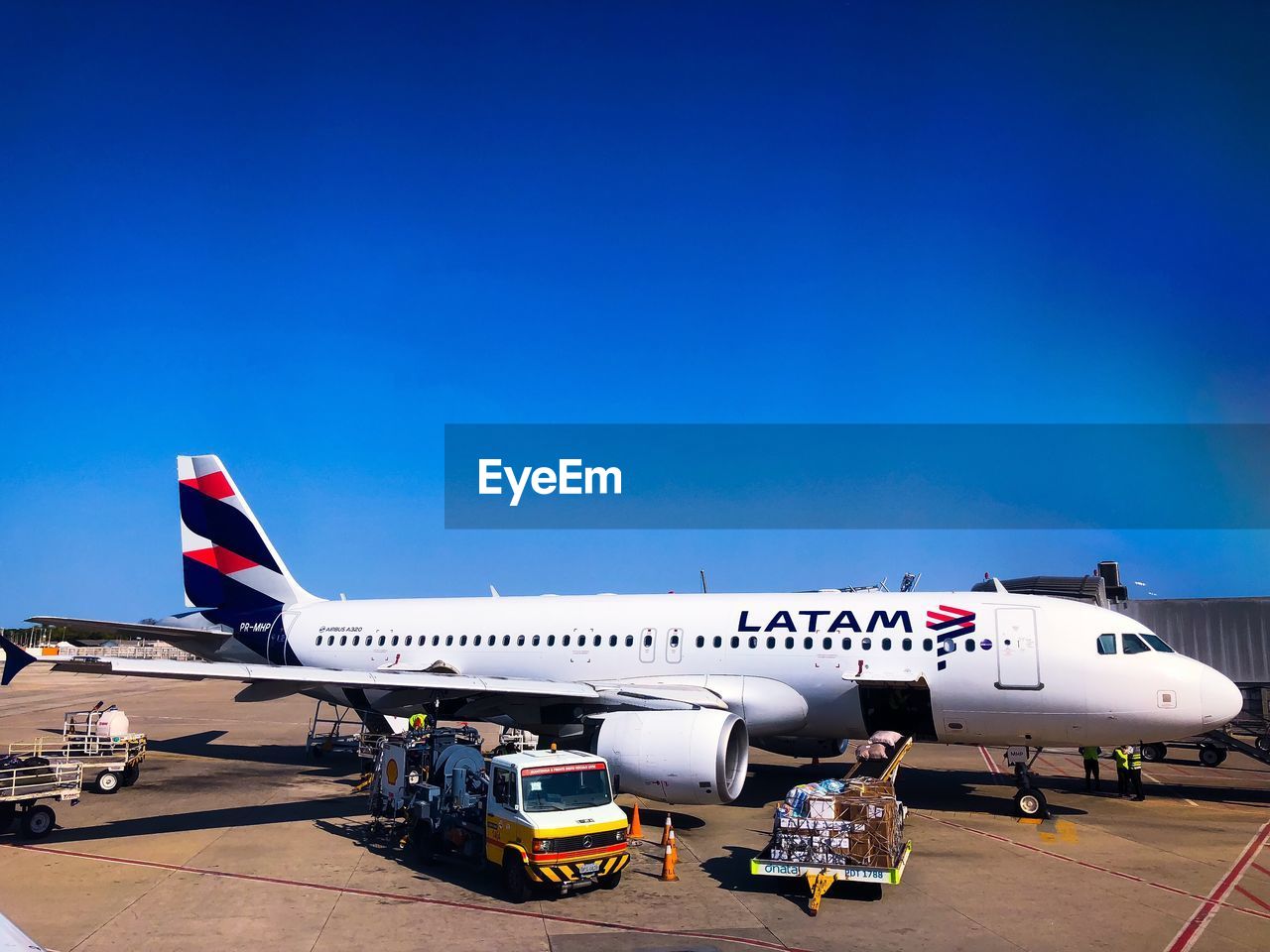 AIRPLANE ON RUNWAY AGAINST SKY