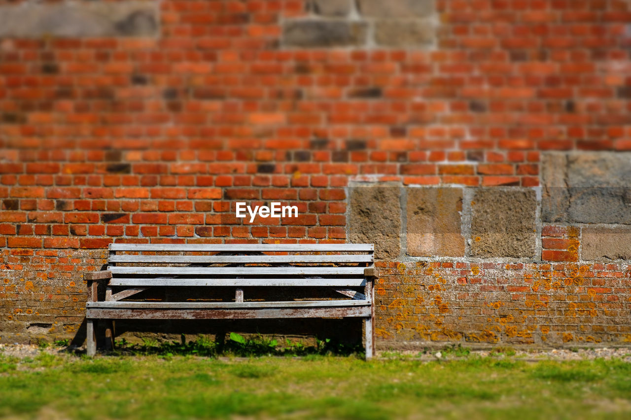 EMPTY BENCH AGAINST WALL