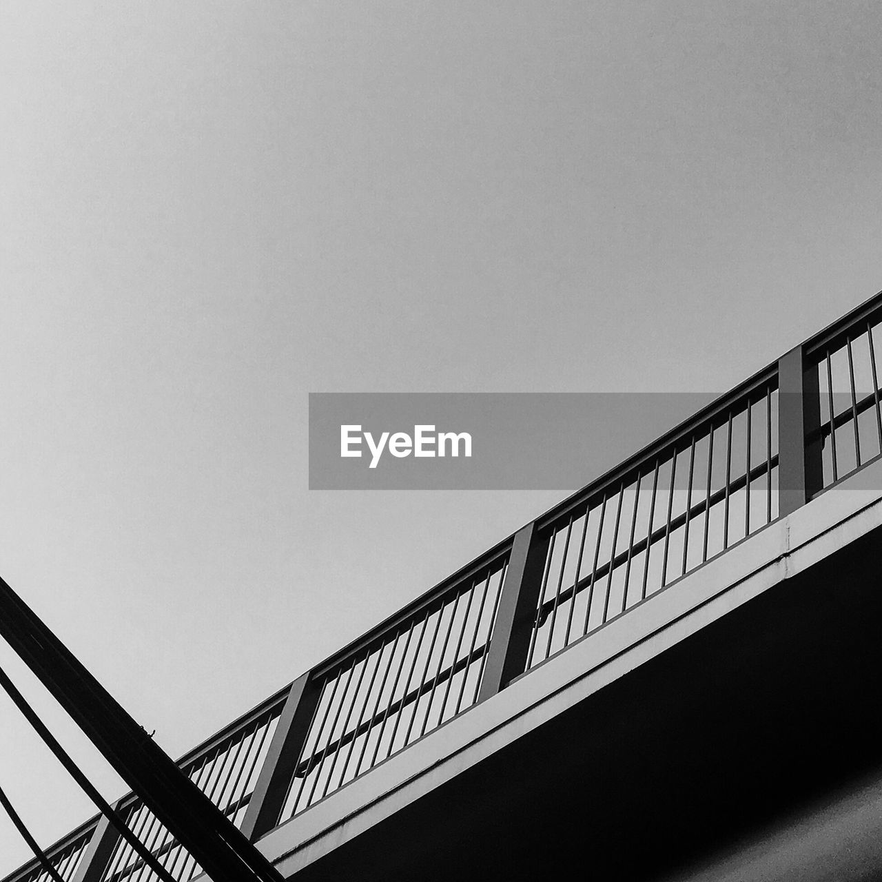 LOW ANGLE VIEW OF RAILING BRIDGE AGAINST CLEAR SKY