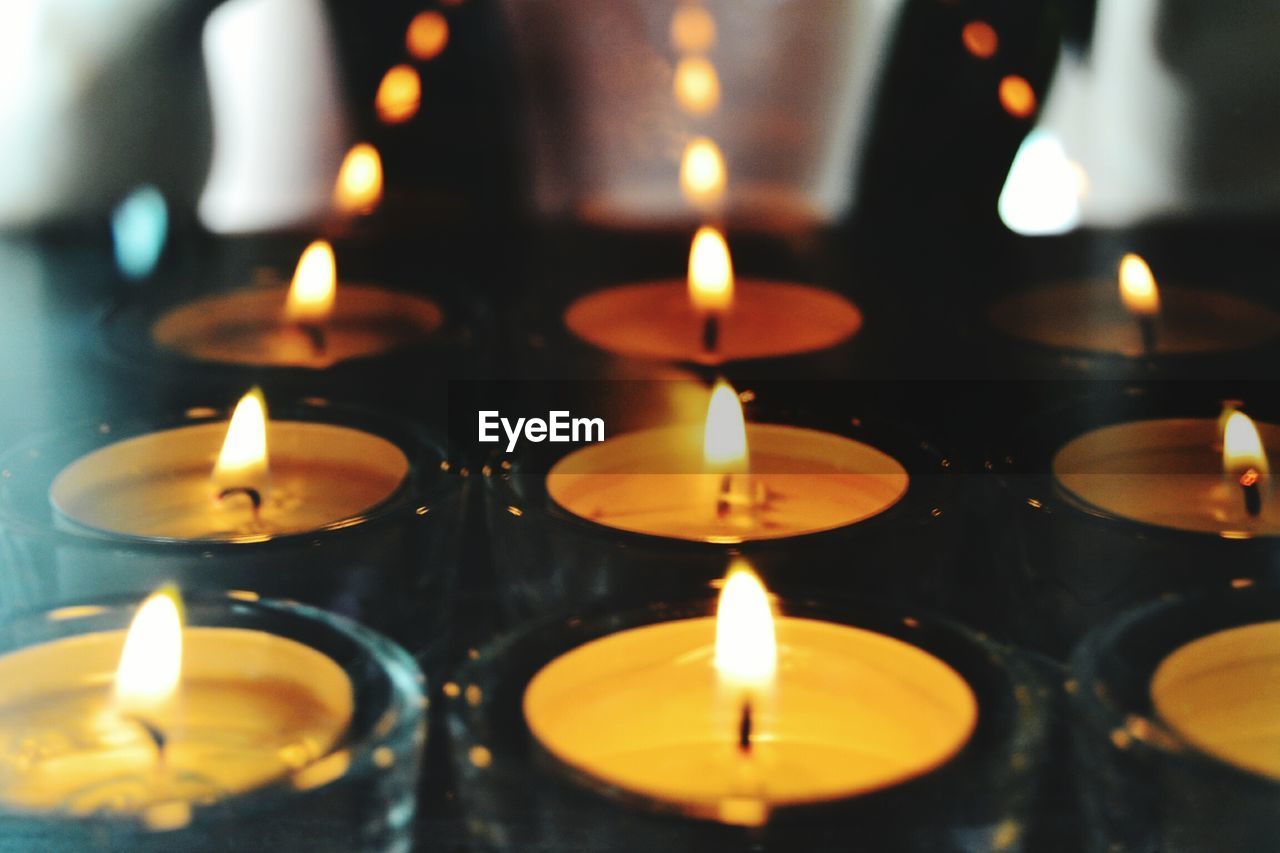 CLOSE-UP OF LIT TEA LIGHT CANDLE