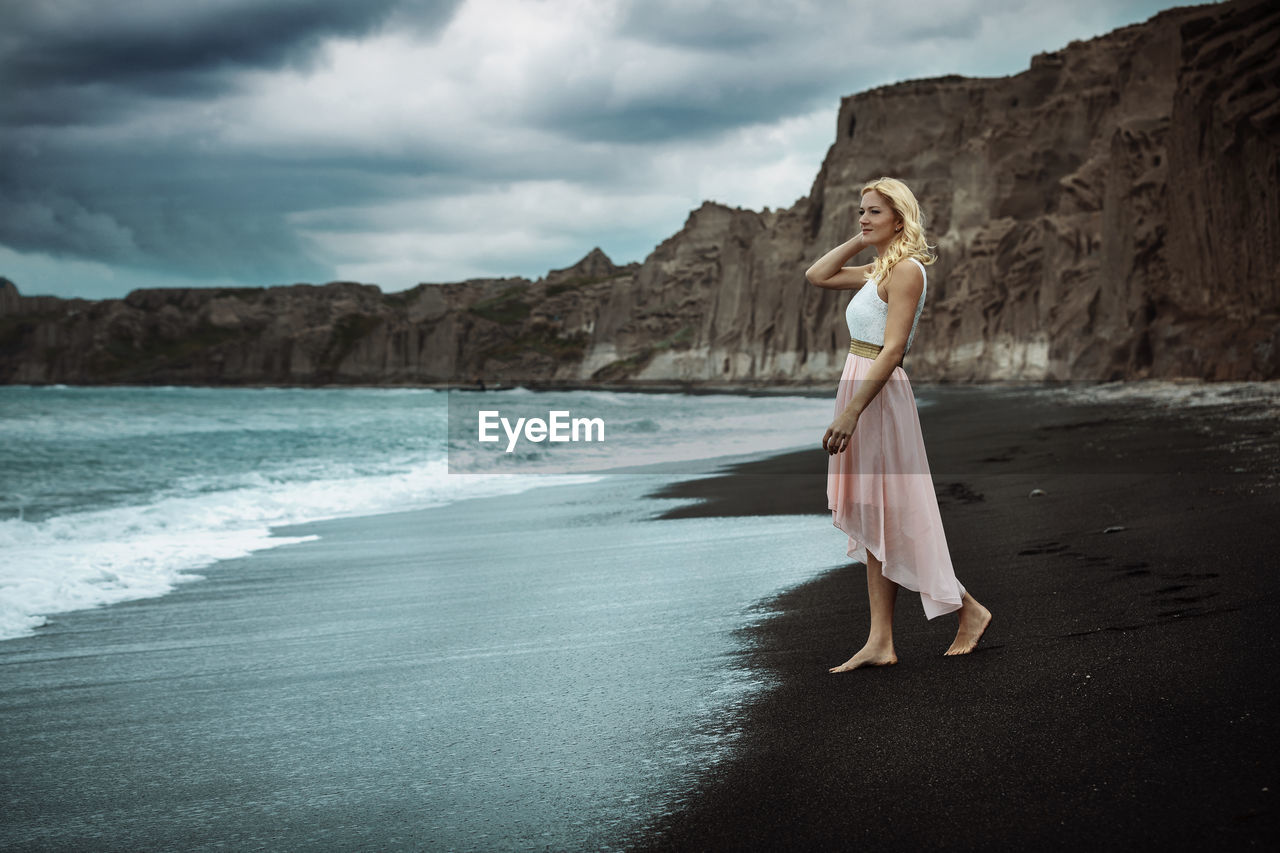 Full length of woman walking at beach