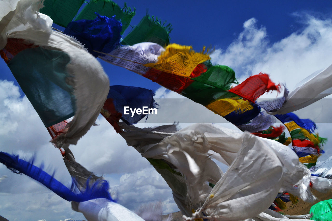 Low angle view of colorful prayer flags against sky