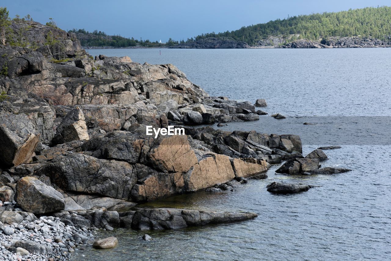 Rocks on beach against sky