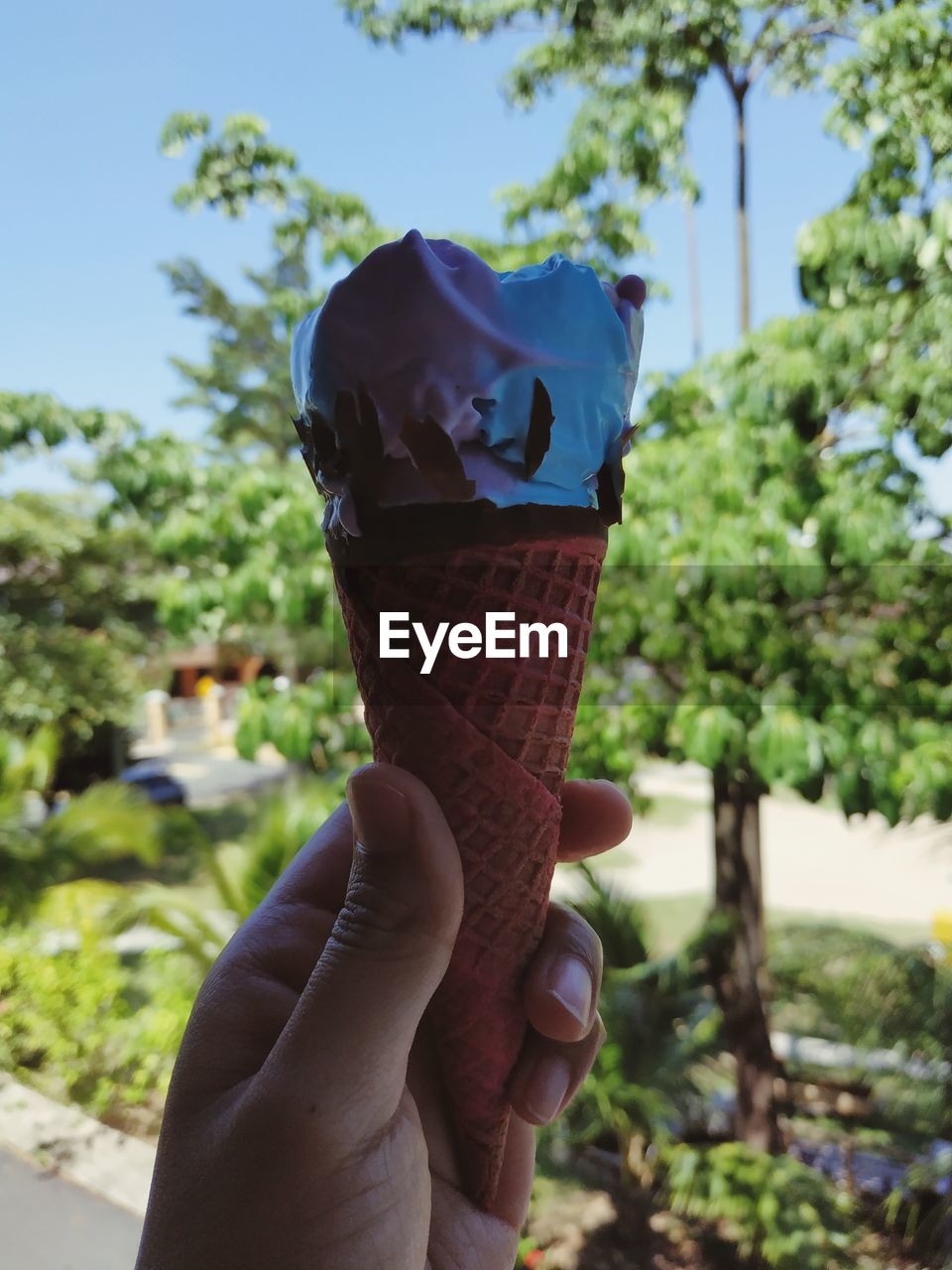 Hand of a person holding ice cream cone