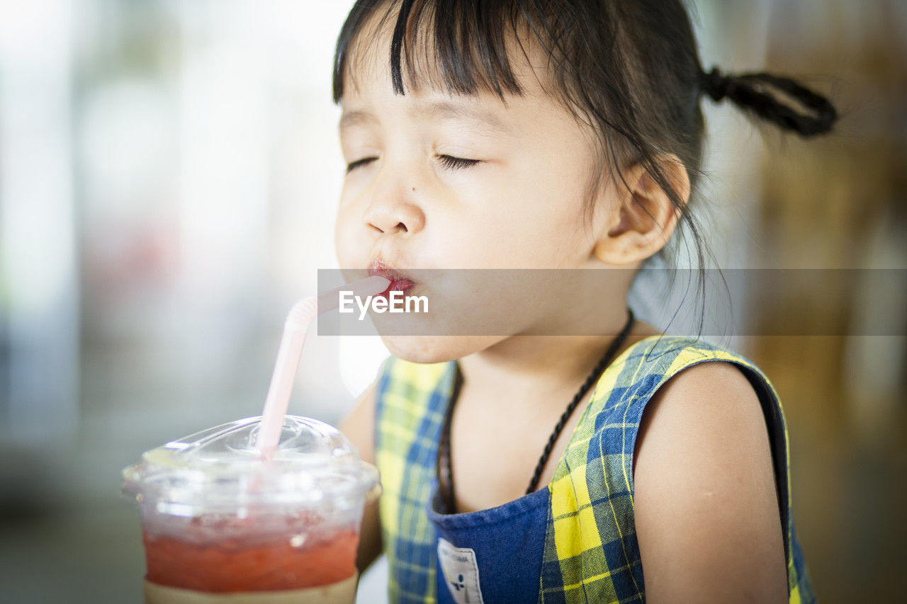 close-up of girl drinking juice