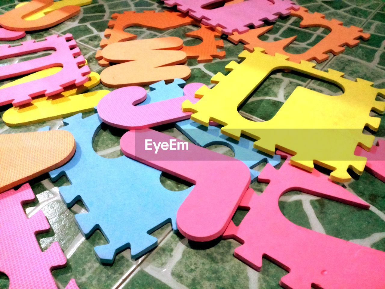 HIGH ANGLE VIEW OF MULTI COLORED TOY ON TABLE