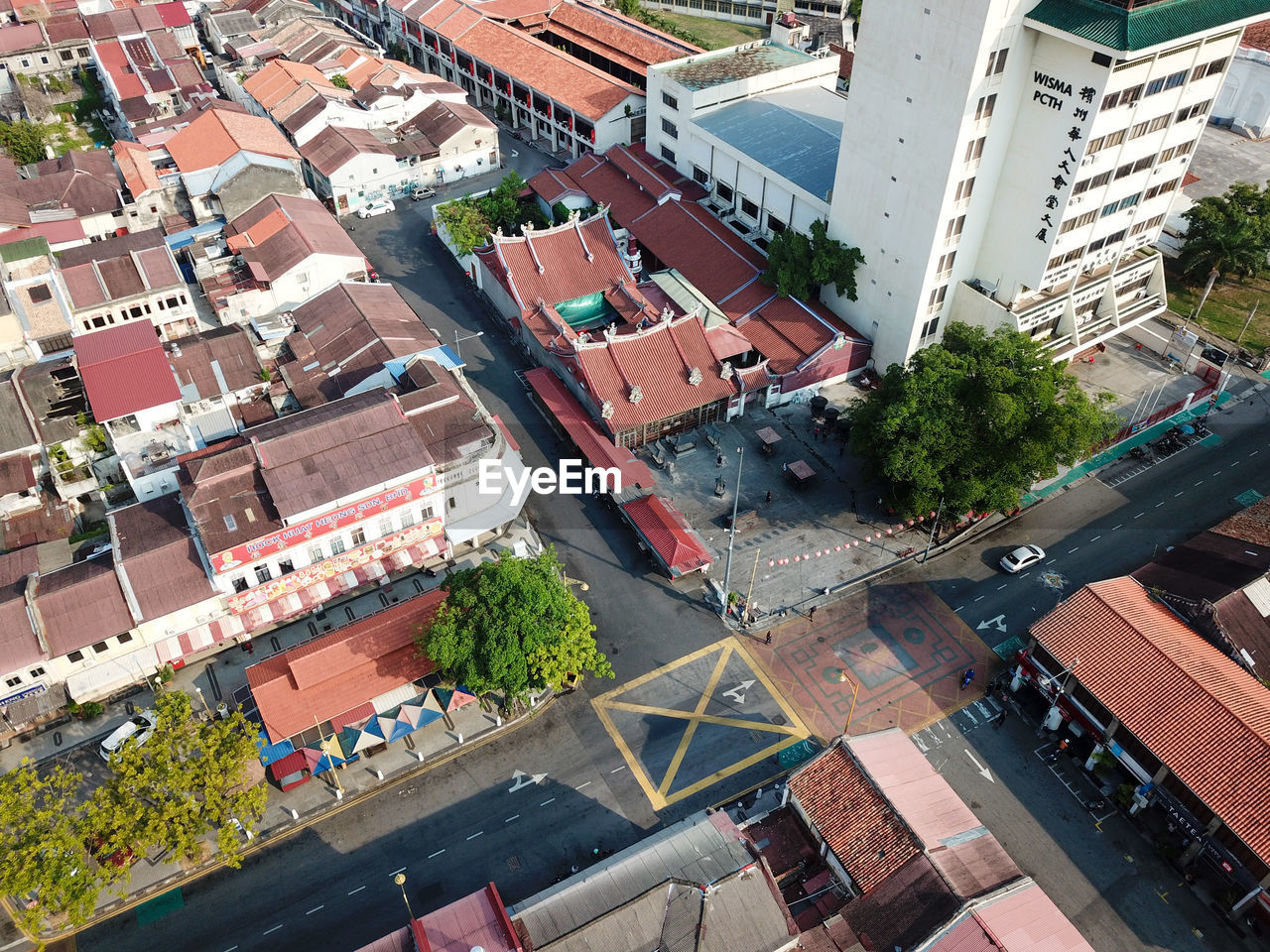 HIGH ANGLE VIEW OF STREET AMIDST BUILDINGS