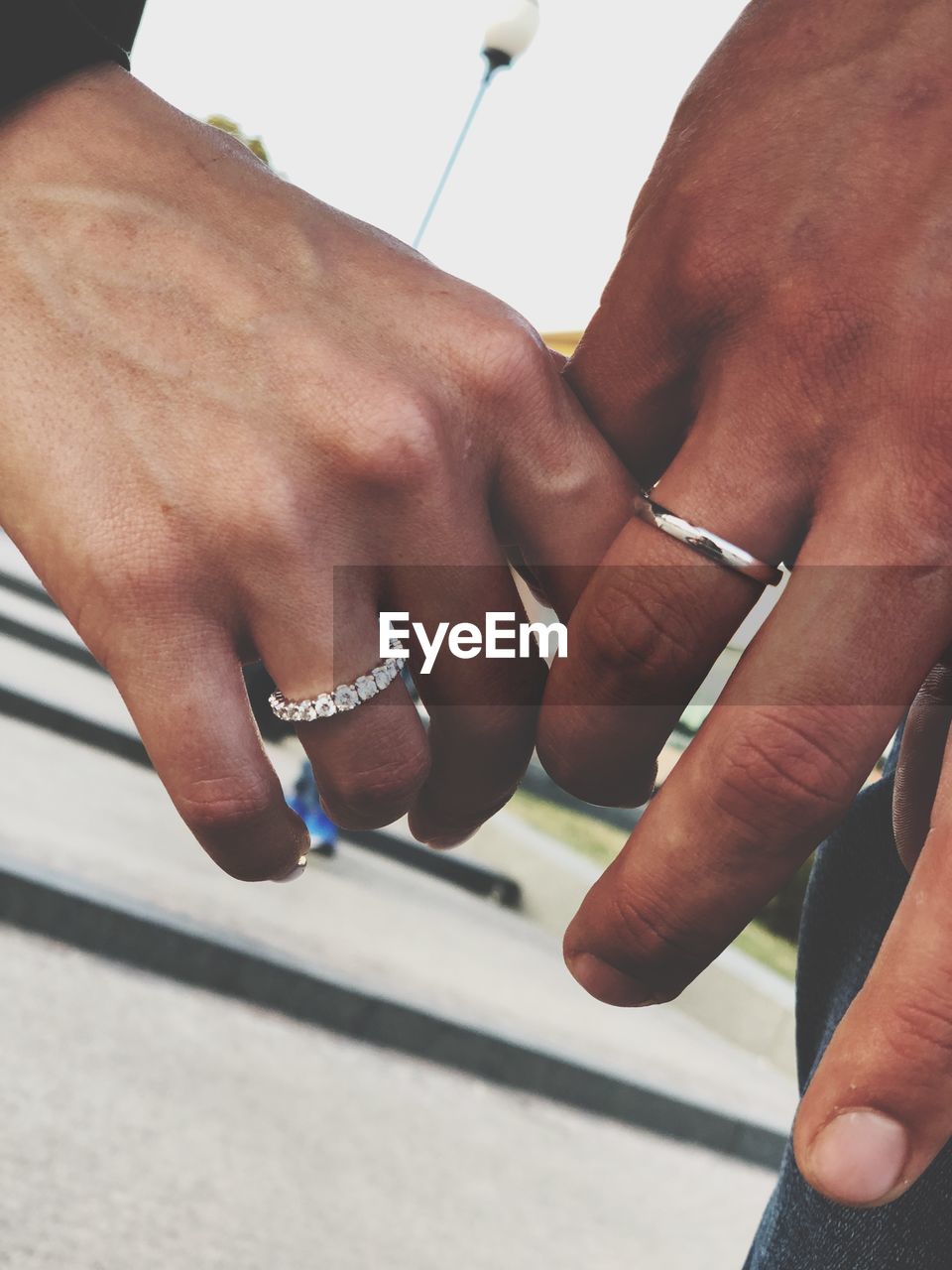 Cropped image of couple holding hands outdoors