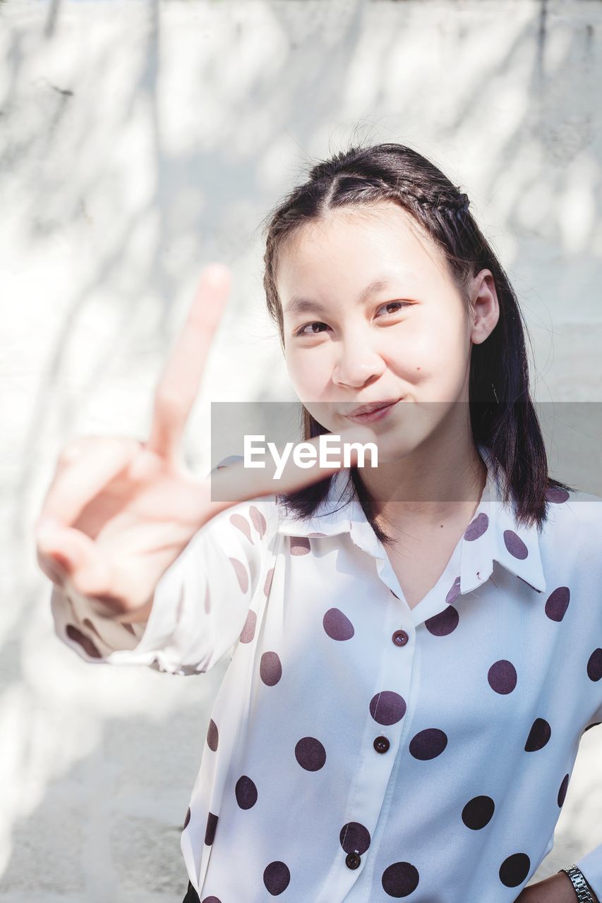 Portrait of smiling girl standing outdoors