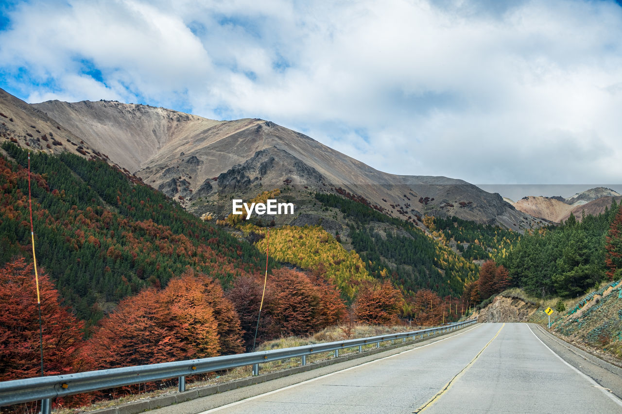 high angle view of road by mountains against sky