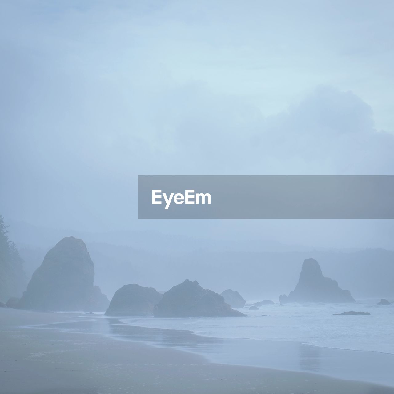 Scenic view of sea and mountains against sky