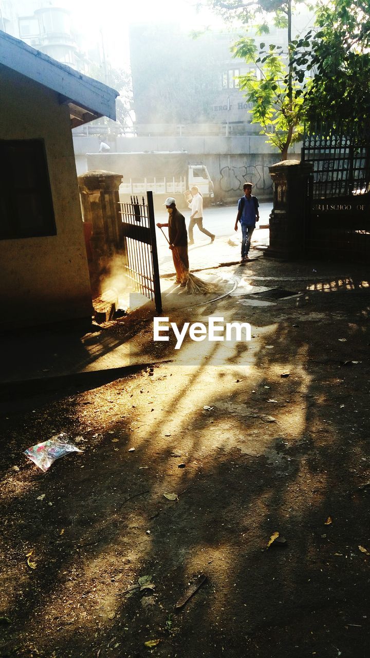 PEOPLE WALKING IN FRONT OF BUILDING