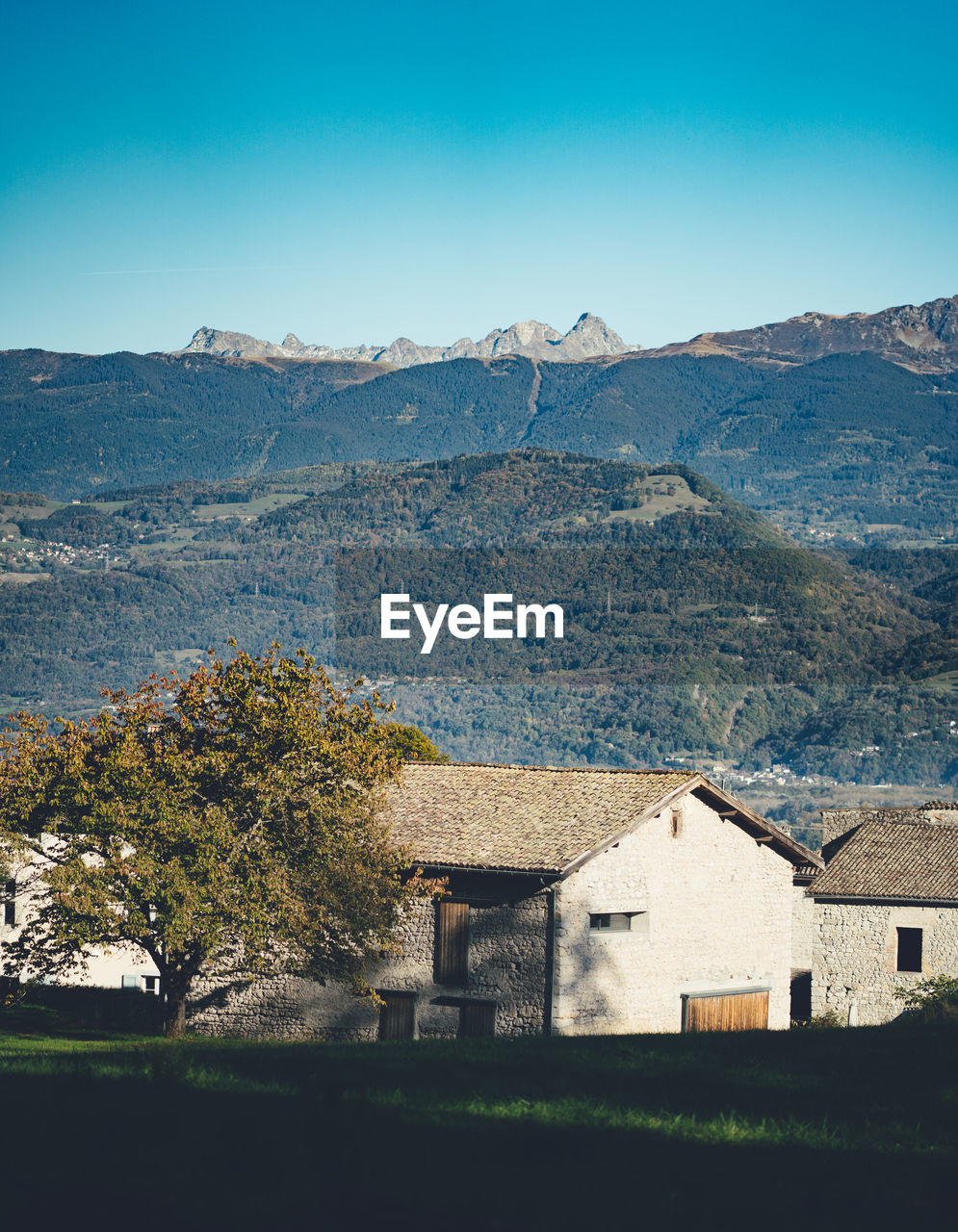 Houses on mountain against sky