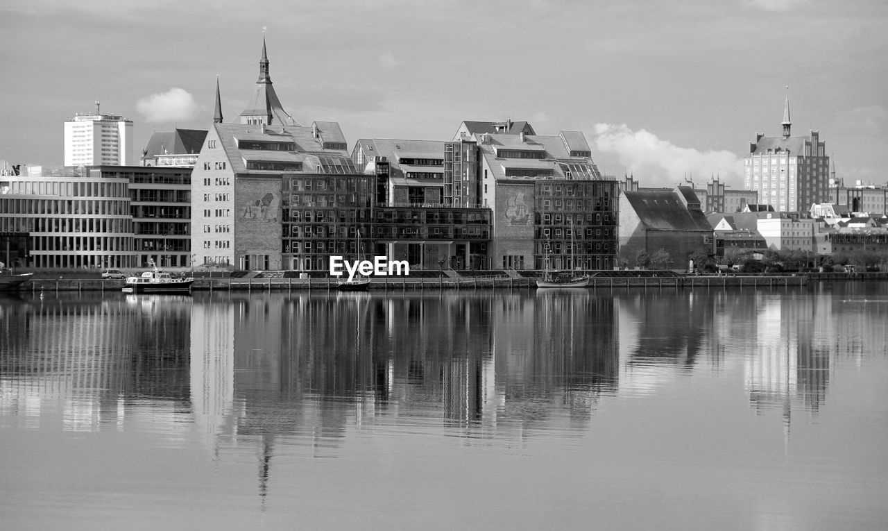 Reflection of buildings on river in city