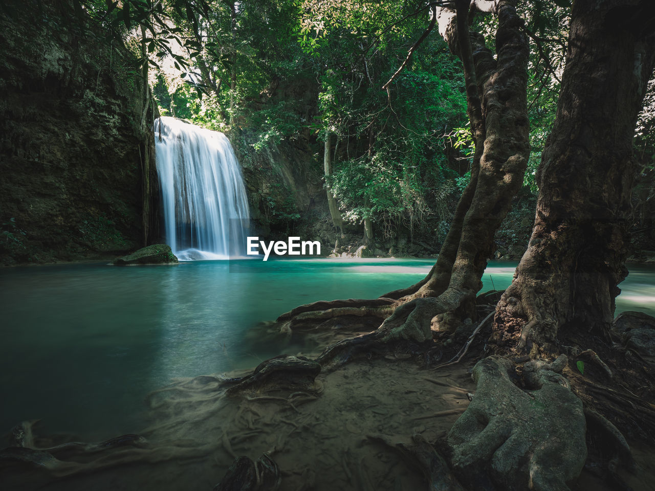 Epic waterfall smooth stream with emerald pond in rainforest. erawan falls, kanchanaburi, thailand.