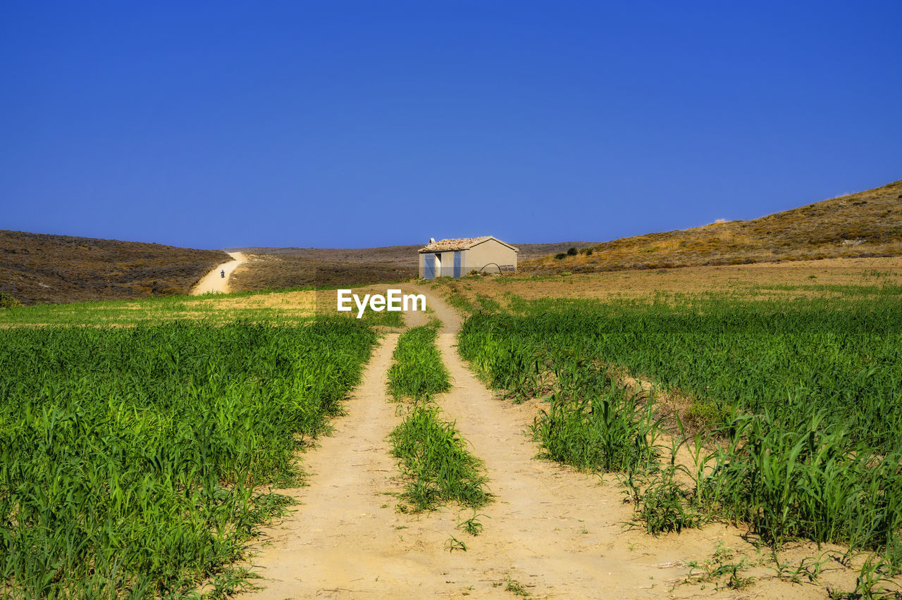 Scenic view of land against clear blue sky