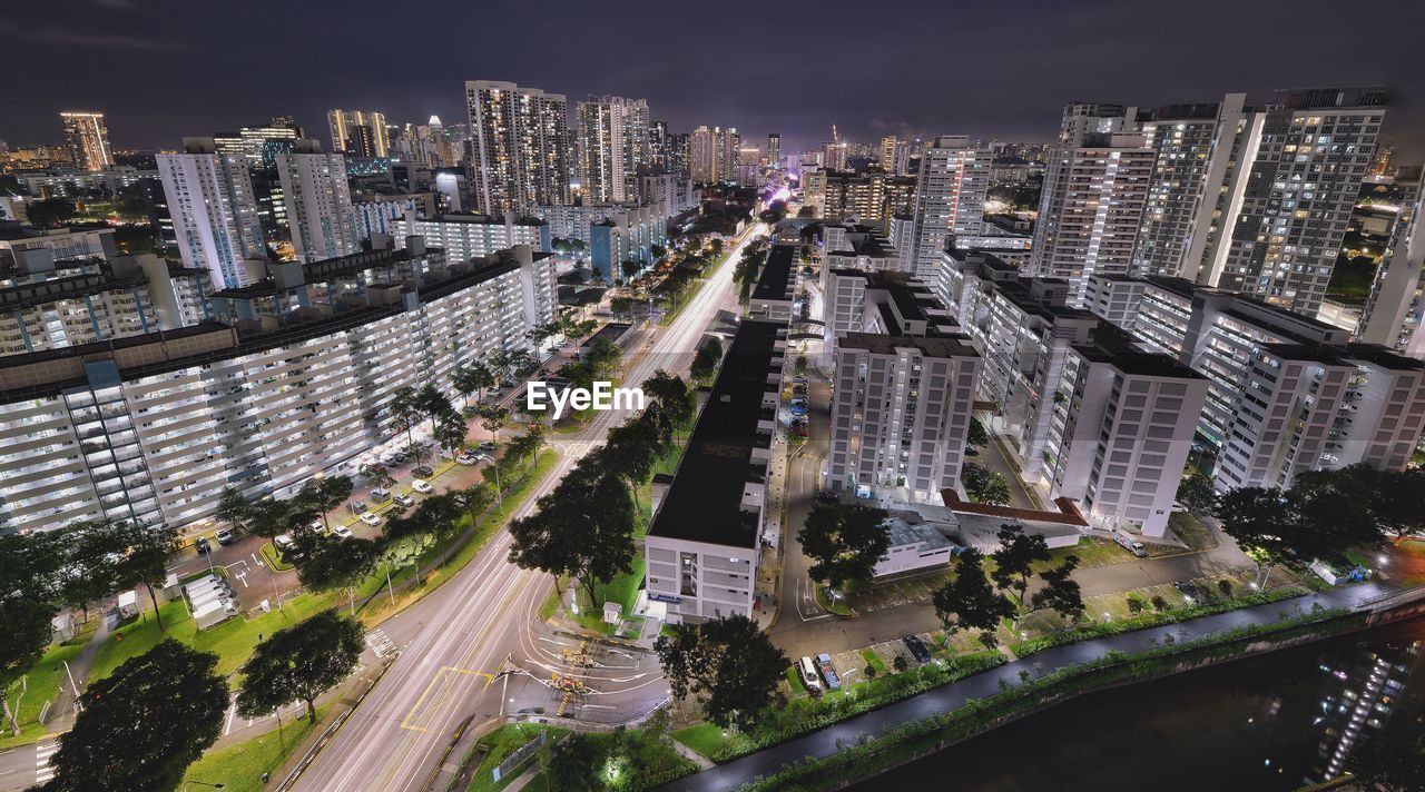 High angle view of street amidst buildings at night