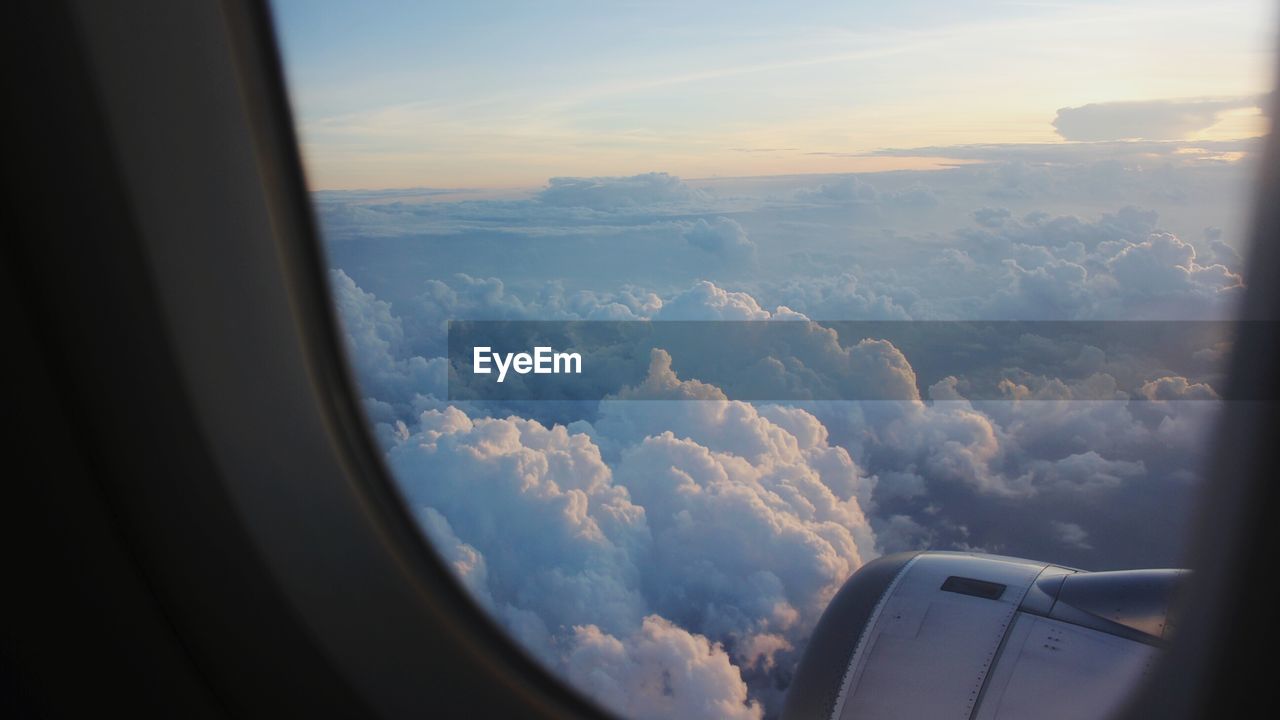 Cloudy sky seen through airplane window