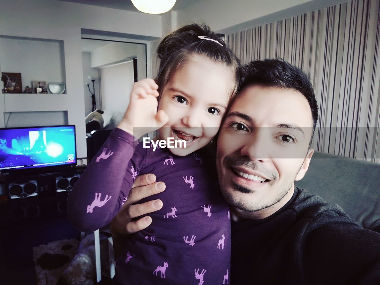 Portrait of father and daughter at home