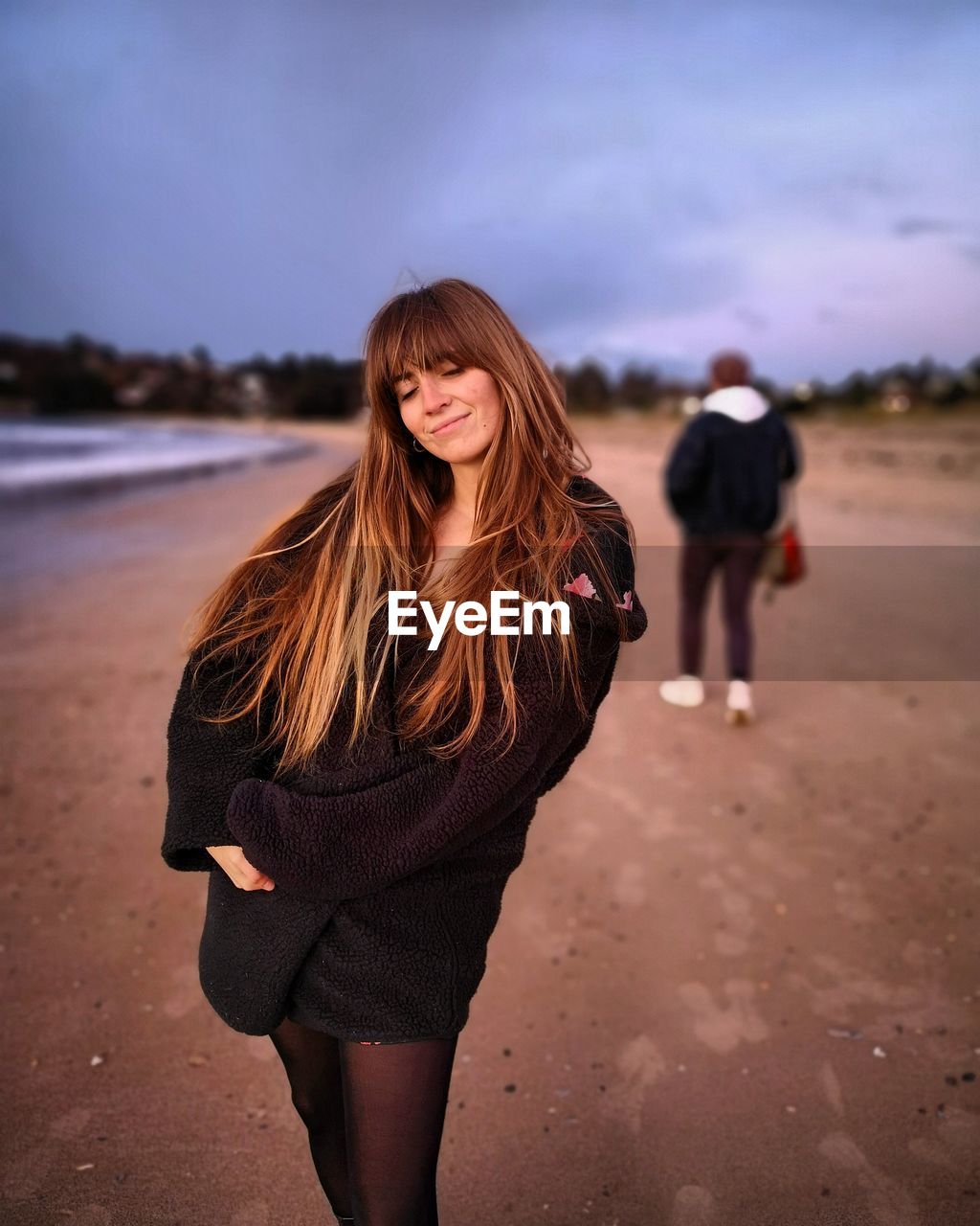 Smiling woman standing at beach