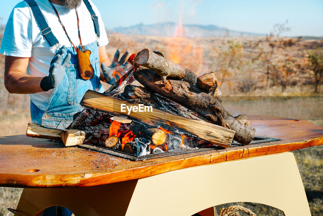 Man preparing food on barbecue grill