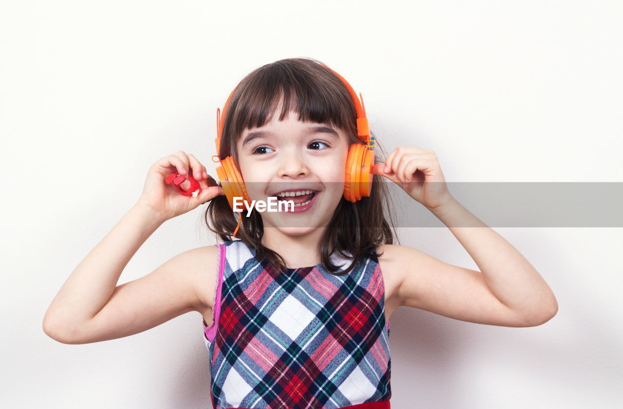 portrait of young woman holding toy against white background