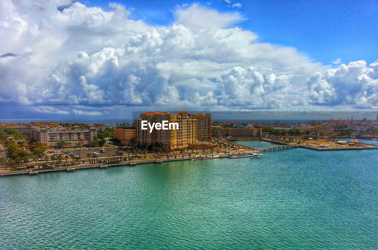 View of cityscape against cloudy sky