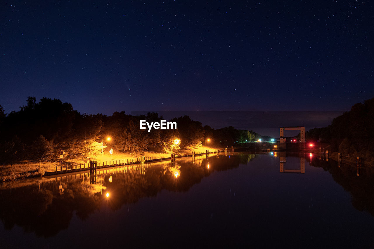 VIEW OF ILLUMINATED CITY AT NIGHT