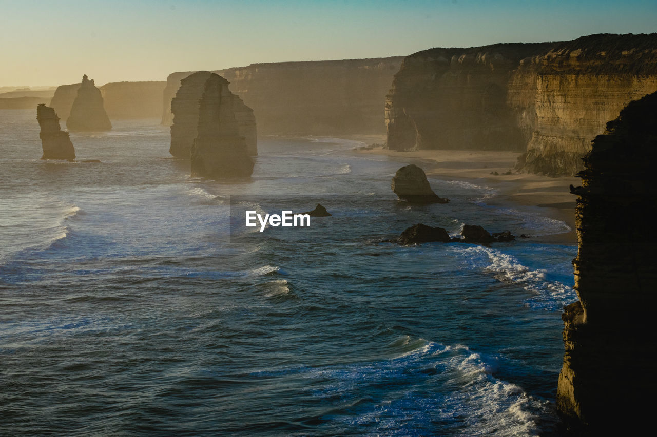 ROCKS IN SEA AGAINST ROCK FORMATION