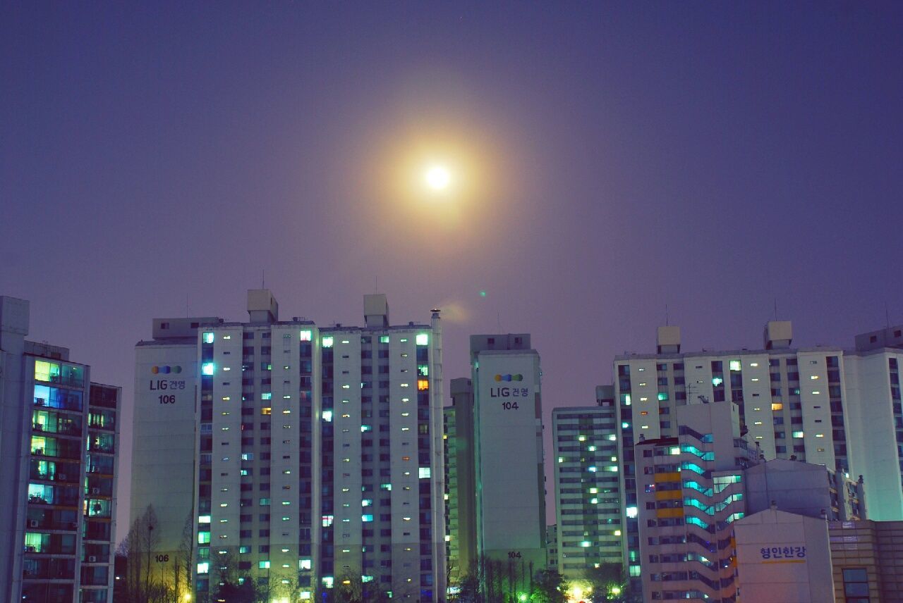 ILLUMINATED BUILDINGS IN CITY AT NIGHT