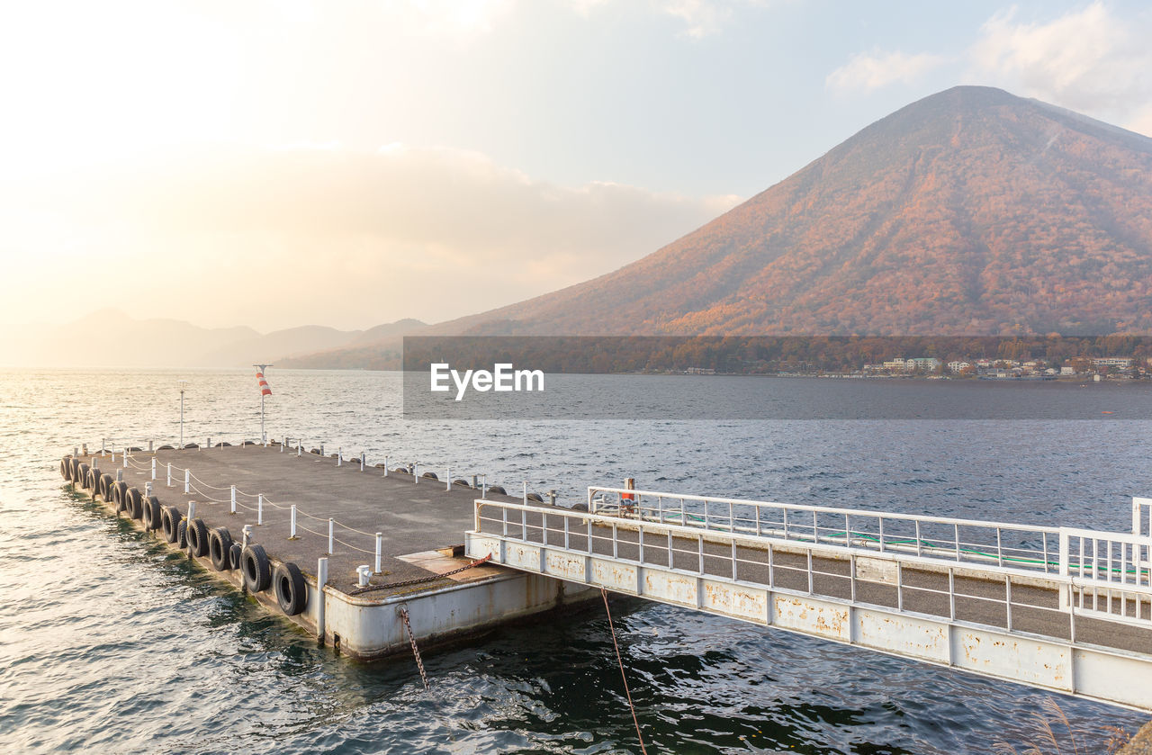 Scenic view of sea and mountains against sky