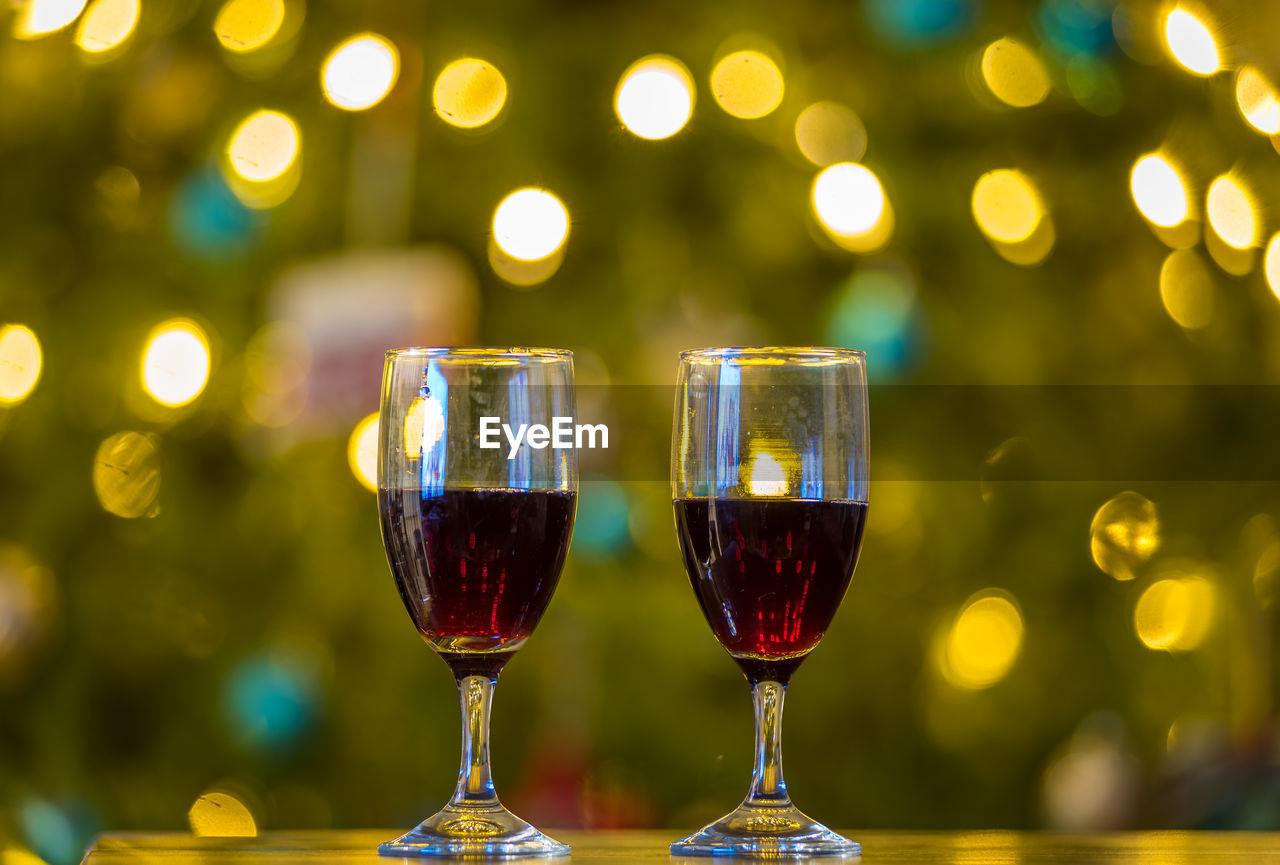 Close-up of red wine in glasses on table