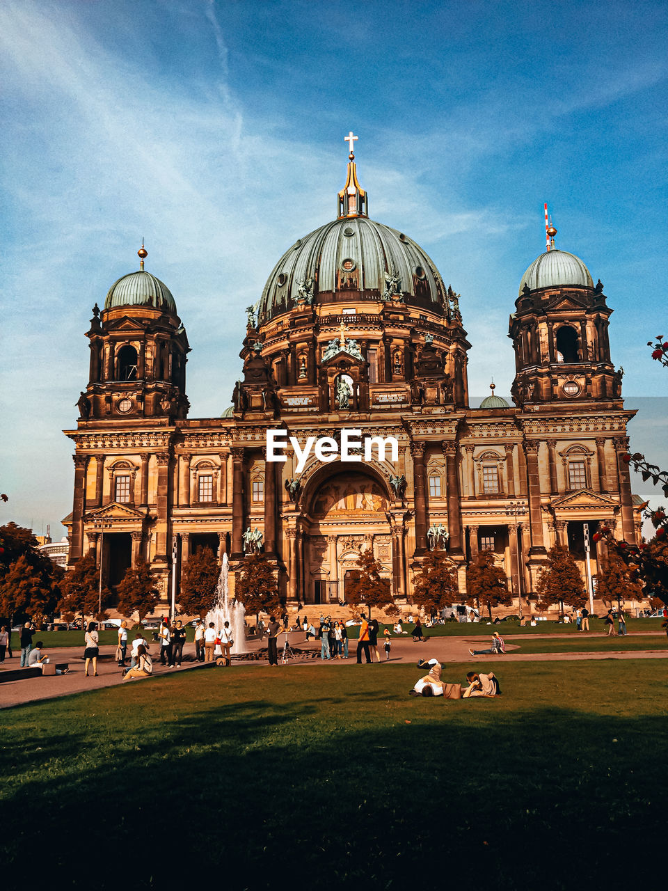 Group of people in front of building berliner dom against sky