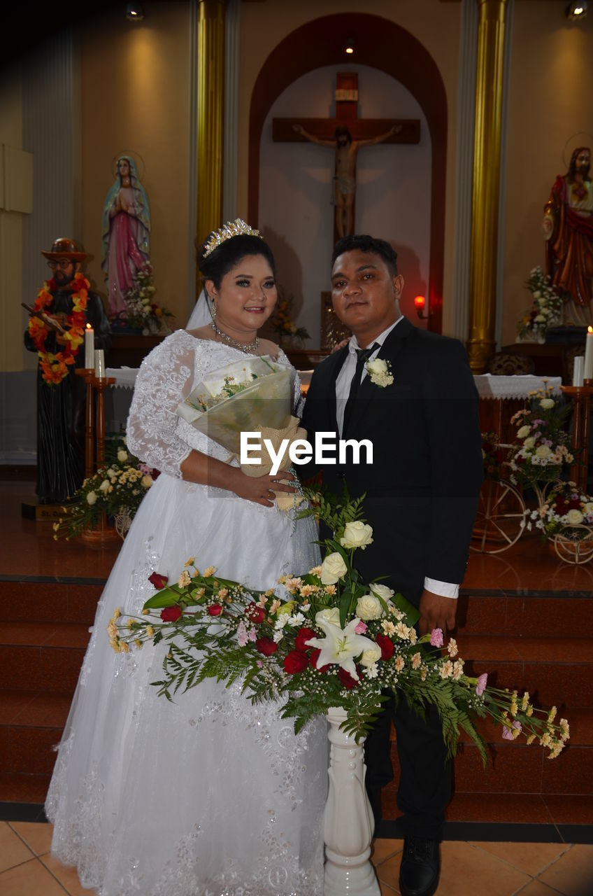 COUPLE HOLDING FLOWERS