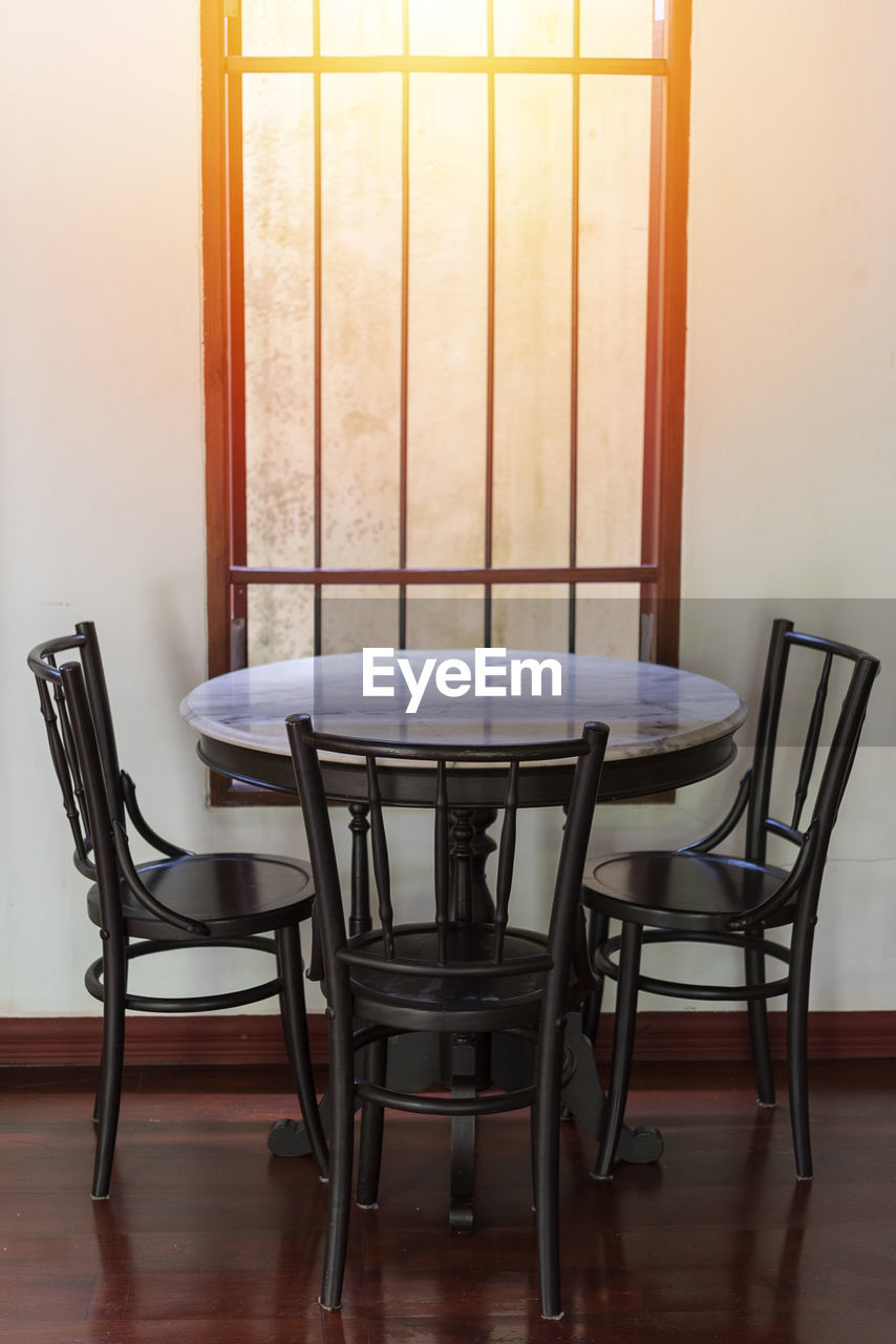 EMPTY CHAIRS ON TABLE AT HOME