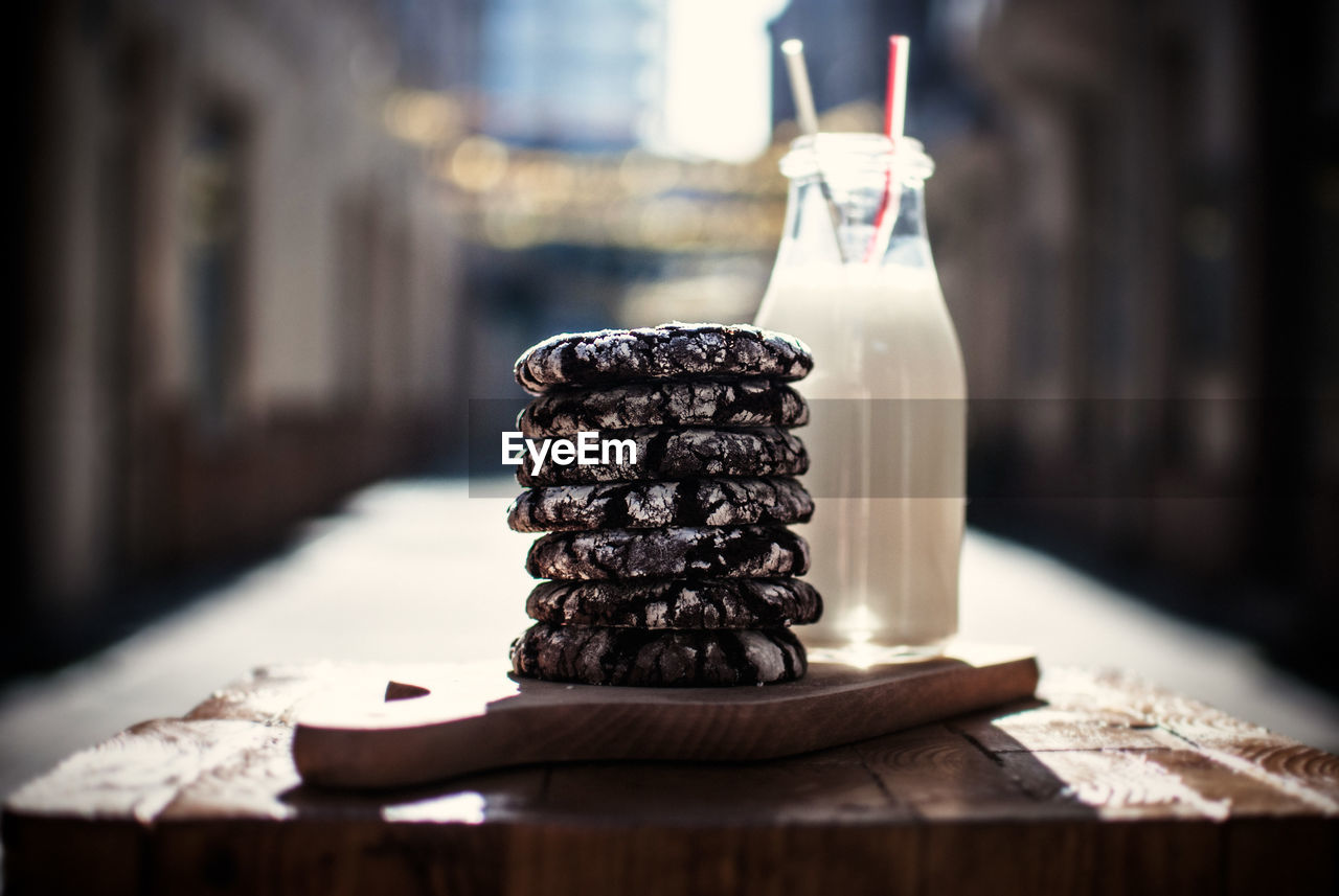 Stack of cookies with milk served on table