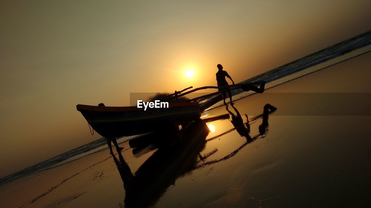 FISHING NET IN SEA DURING SUNSET