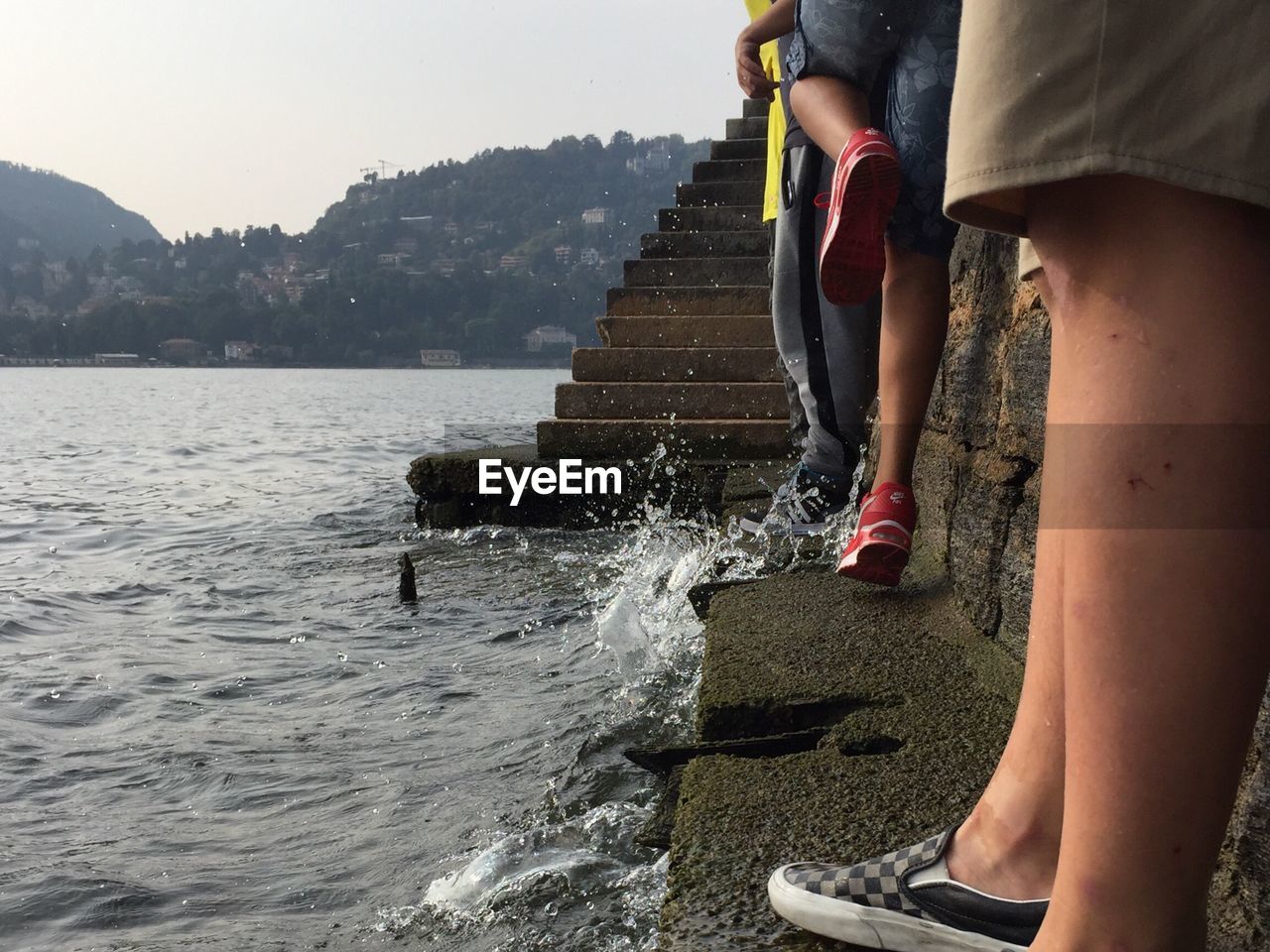 FRIENDS SPLASHING WATER IN MOUNTAINS