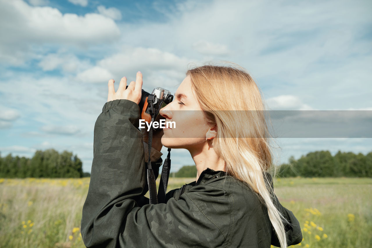 side view of man photographing with camera