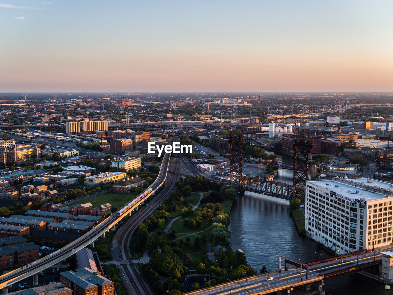 High angle view of river amidst buildings in city against sky