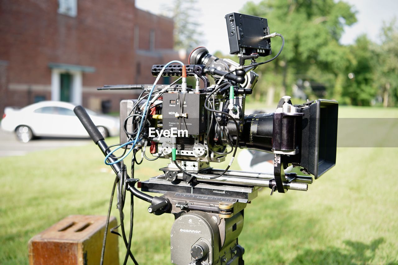 CLOSE-UP OF CAMERA ON FIELD BY LAND