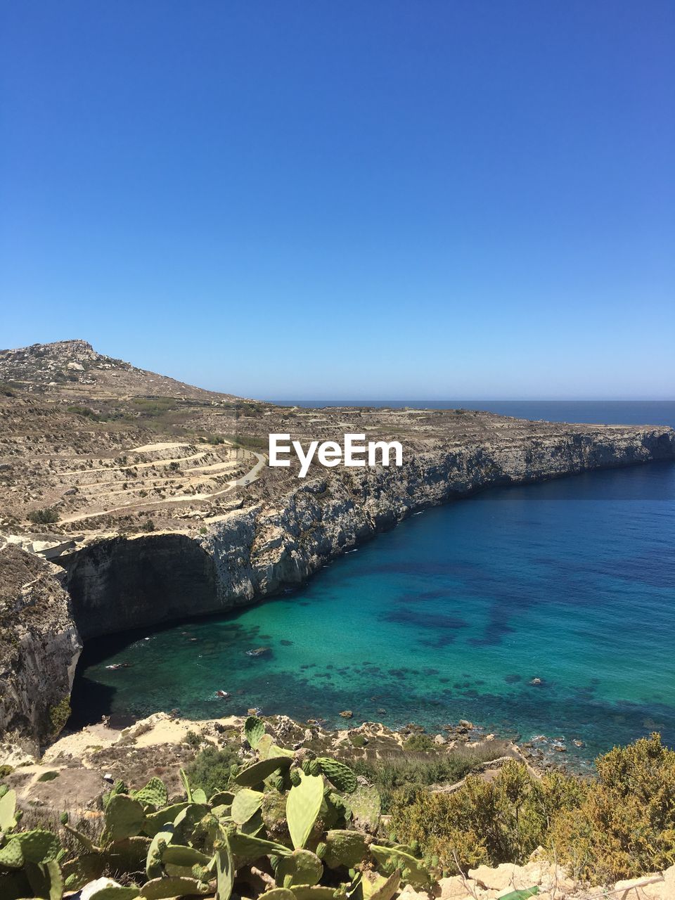 Scenic view of sea against clear blue sky