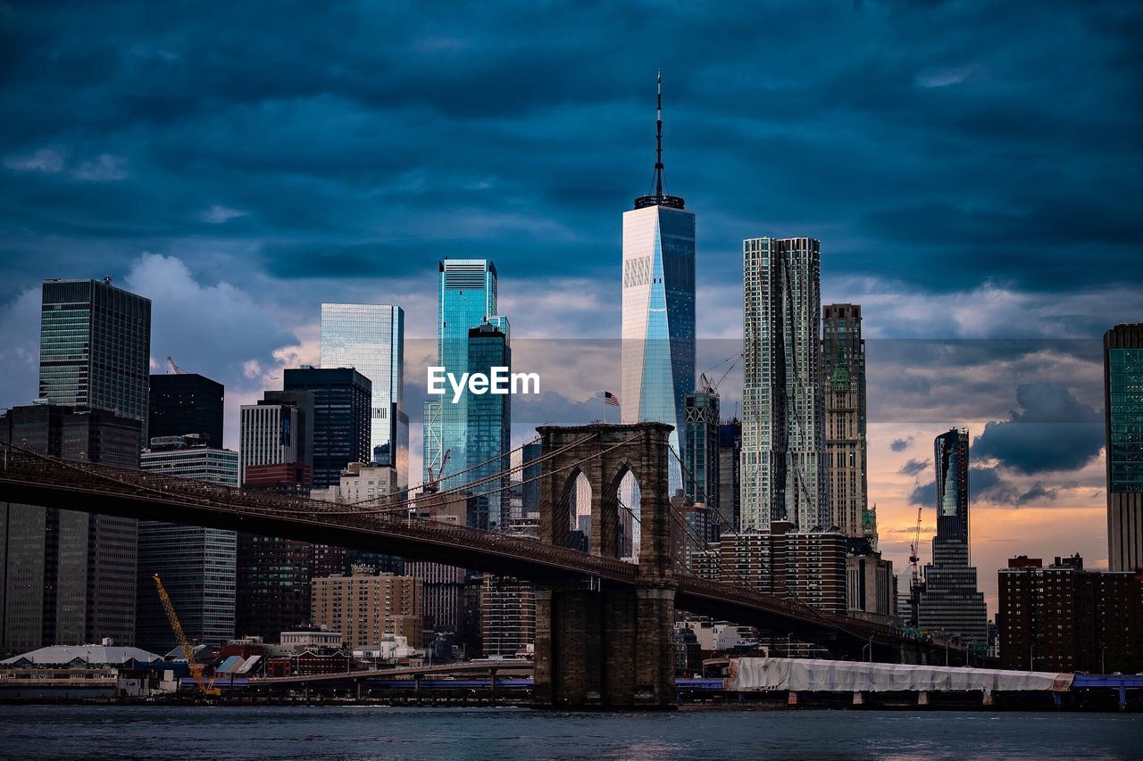 Modern buildings in city against cloudy sky